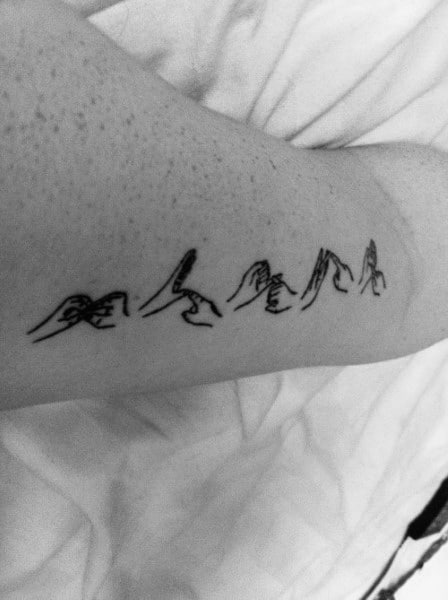 minimalist black ink tattoo of hands spelling a word in American Sign Language, designed with delicate linework along the arm