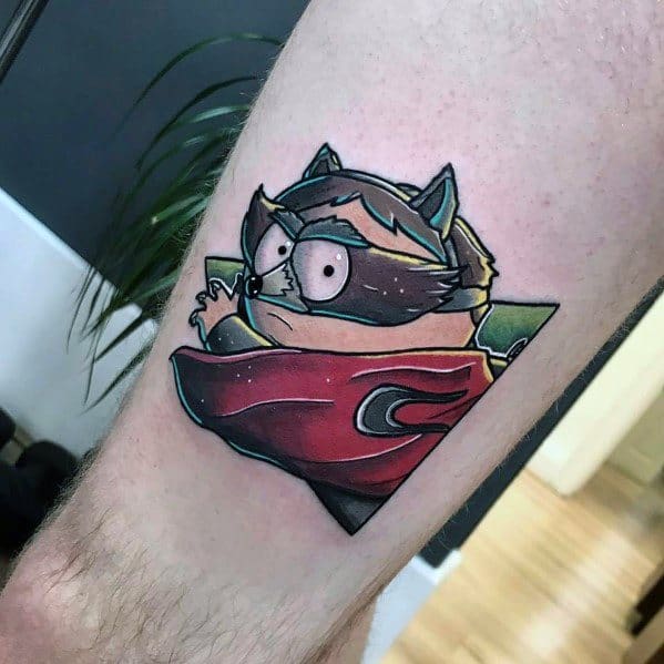 South Park tattoo of Cartman as The Coon, featuring bold colors, dynamic shading, and a sharp geometric frame for a striking design.
