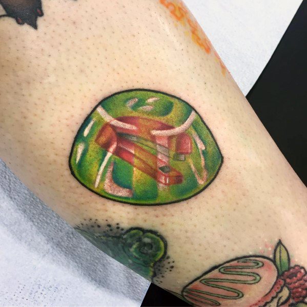 Color tattoo of a red stapler encased in green Jell-O, referencing Jim’s classic prank on Dwight from *The Office*.