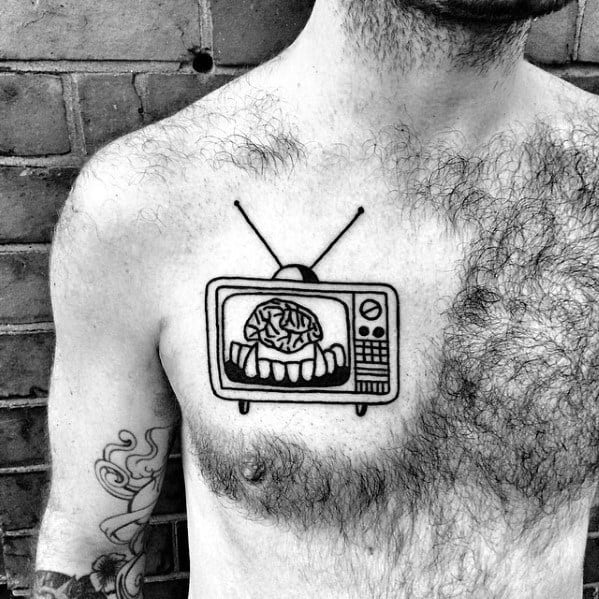 Minimalist black ink tattoo of a vintage TV on the chest, displaying a brain held by sharp teeth, with simple bold lines and classic antennas.