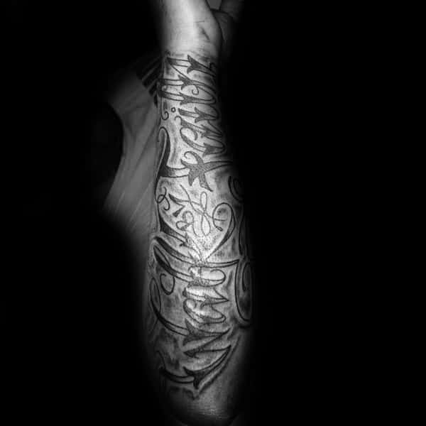 Forearm tattoo with intricate script lettering and bold flourishes, creating a striking and detailed design with deep symbolic meaning.