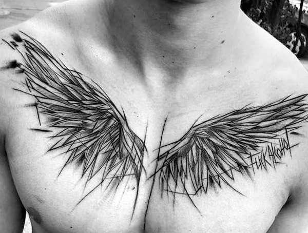 Black ink angular wings tattoo spanning across a person's chest
