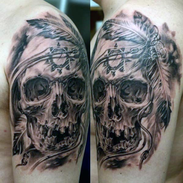 Tattoo of a skull with feathers and intricate details on an upper arm