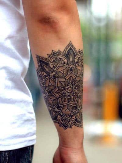Intricate mandala tattoo on a person's forearm