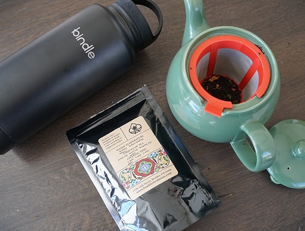 Teapot With Tea And Black Bindle Bottle