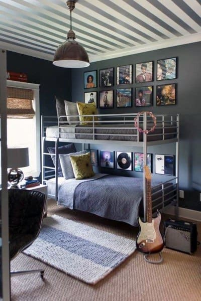 A cozy room with bunk beds, music-themed decor, a guitar, and albums on the wall