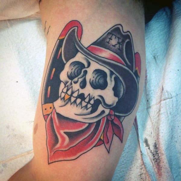 Texan Skull With Cowboy Hat Sailor Jerry Style Tattoo On Mans Inner Bicep