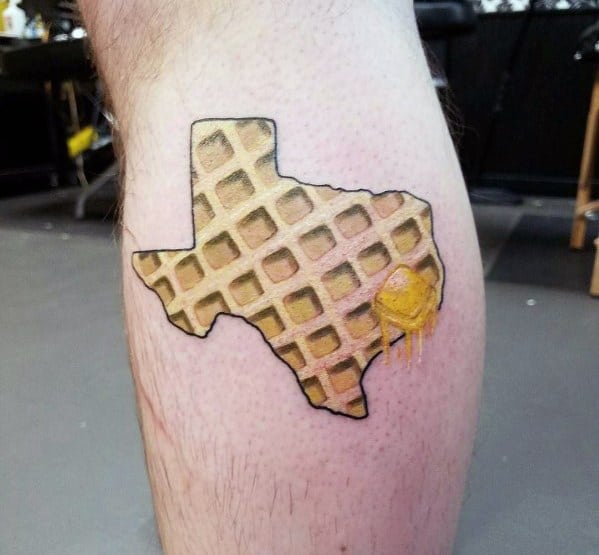 Texas-shaped waffle tattoo with realistic texture, melted butter, and syrup, combining state pride with a creative breakfast-inspired design.