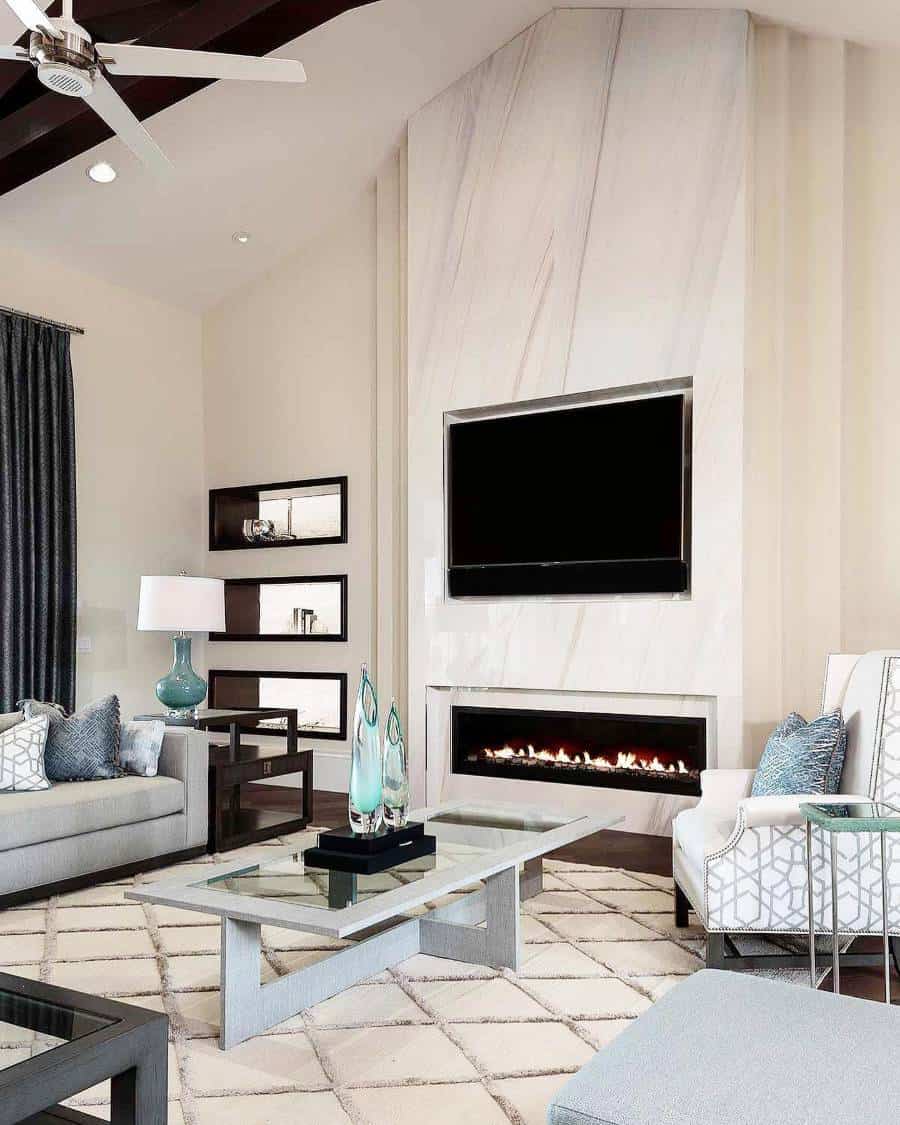 Modern living room with an accent wall, marble fireplace, flat-screen TV, sofa set, and glass coffee table