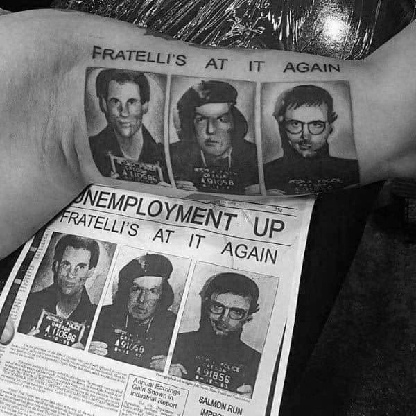 Black and gray tattoo of the Fratelli family’s mugshots from *The Goonies*, featuring the headline "Fratelli's At It Again," replicating a newspaper clipping.
