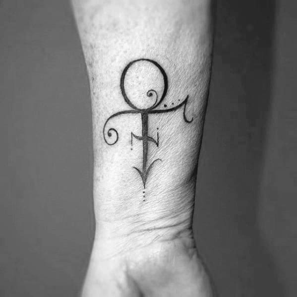 Prince-inspired tattoo of an abstract symbol with swirling lines on a person's forearm