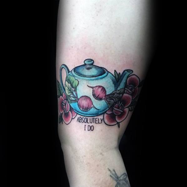 Color tattoo of Pam’s teapot from *The Office*, decorated with beets and flowers, featuring the phrase "Absolutely, I do," referencing Jim and Pam’s love story.
