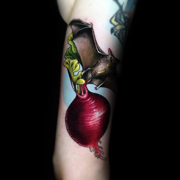 Color tattoo of a bat carrying a beet, referencing Dwight Schrute’s love for beets and the *Bat Attack* scene from *The Office*.