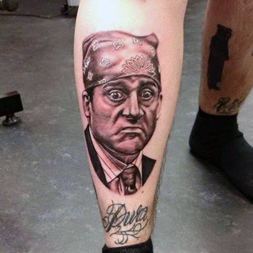 Black and white tattoo of Michael Scott as "Prison Mike" from *The Office*, featuring his iconic purple bandana and exaggerated expression.
