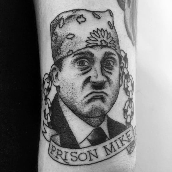 Black and white tattoo of Michael Scott as "Prison Mike" from *The Office*, featuring his iconic purple bandana, a chain design, and a banner reading "Prison Mike."