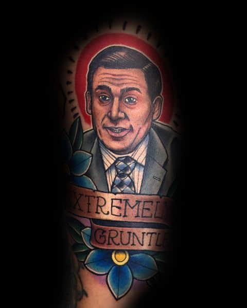 Color tattoo of Michael Scott from *The Office* with a halo-like glow and a banner reading "Extremely Gruntled," referencing his word mix-up.