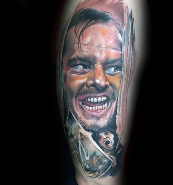 Realistic color tattoo of Jack Torrance from *The Shining*, featuring his iconic “Here’s Johnny!” scene with intense expression and vivid details.