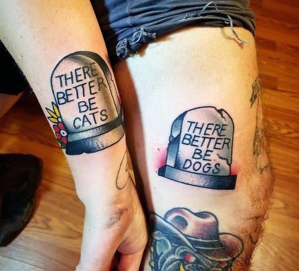 Matching humorous tombstone tattoos reading "There better be cats" and "There better be dogs," celebrating a fun-loving couple's pet preferences in the afterlife.