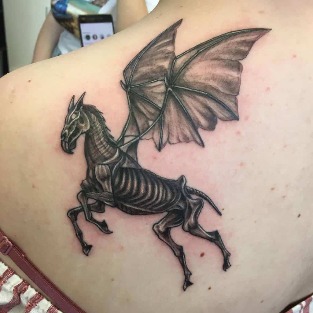 Detailed Harry Potter tattoo of a Thestral, a skeletal winged horse, inked in black and grey with eerie realism