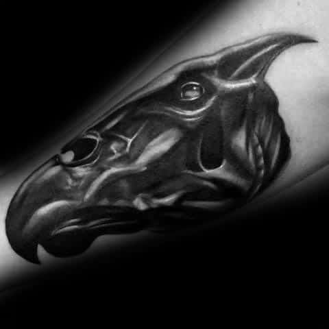 Hyper-realistic Thestral head tattoo with deep black shading and lifelike highlights on the forearm.