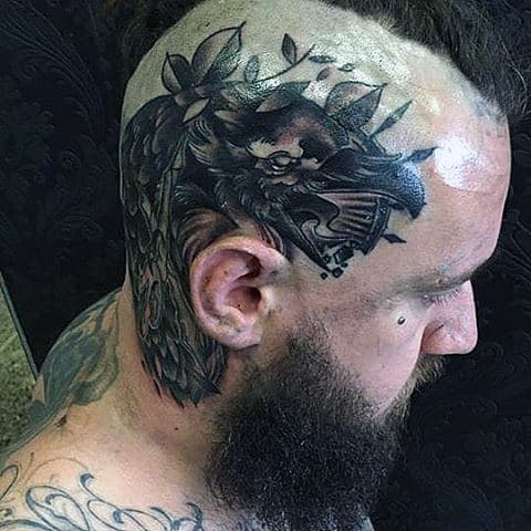 Thick Featherd Black Raven Tattoo On Mens Tonsured Head