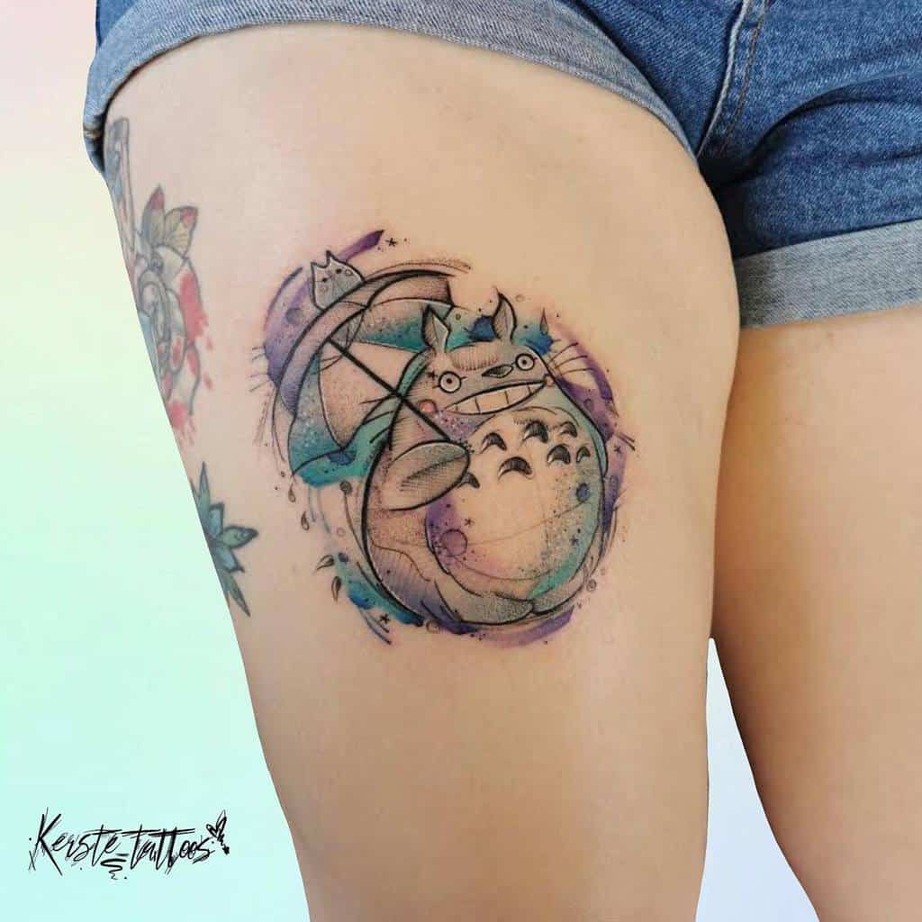 Vibrant thigh tattoo of Totoro with an umbrella, featuring a watercolor splash effect for added whimsy and charm