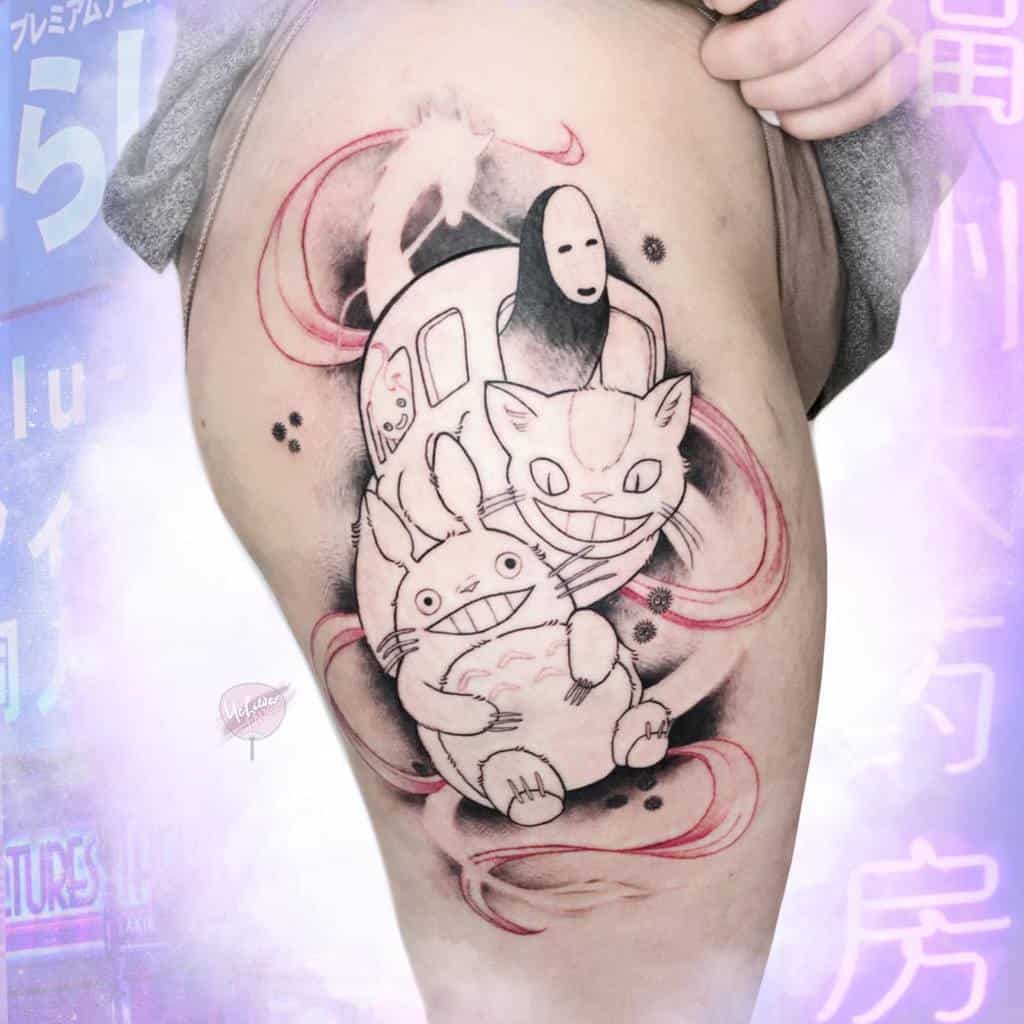 Detailed Studio Ghibli tattoo on the thigh featuring Totoro, Catbus, No-Face, and Haku, with a swirling red and black background