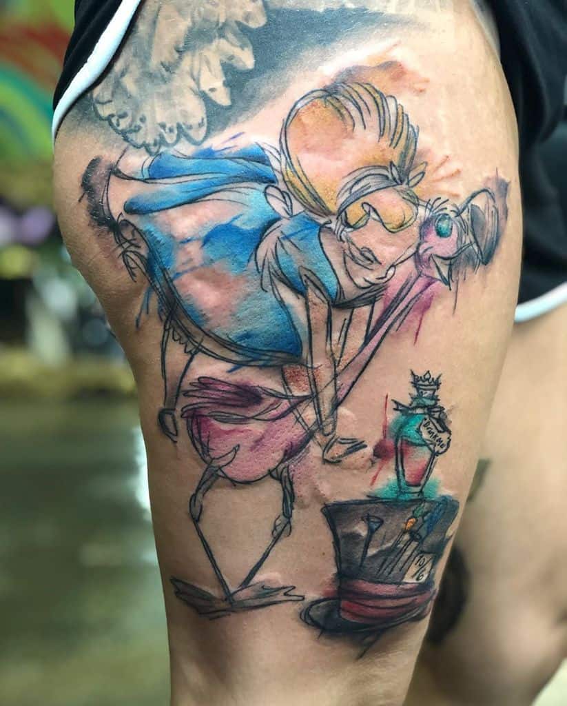 A colorful tattoo depicting Alice bending over a flamingo, with a teacup, a bottle labeled "Drink Me," and the Mad Hatter's hat, inspired by Alice in Wonderland
