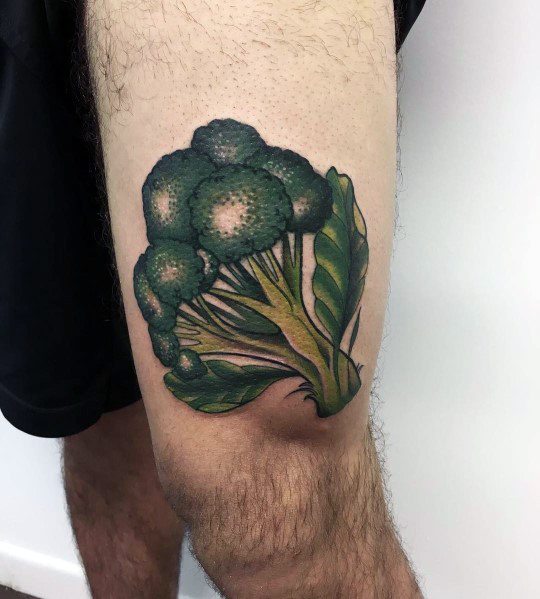 Realistic broccoli tattoo on the thigh, featuring rich green tones, detailed shading, and bold outlines for a vibrant and eye-catching design.