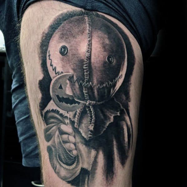 Black and grey tattoo of Sam from *Trick 'r Treat*, featuring his stitched burlap mask and eerie lollipop for a haunting Halloween horror design.