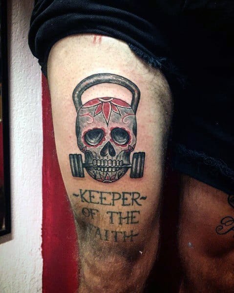 Tattoo of a kettlebell skull with a barbell and "KEEPER OF THE FAITH" text, symbolizing strength, resilience, and dedication to fitness and CrossFit.