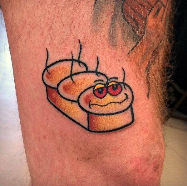 Colorful tattoo of a loaf of bread with a cartoonish, smiling face and red eyes, emitting steam, creating a playful and humorous design.