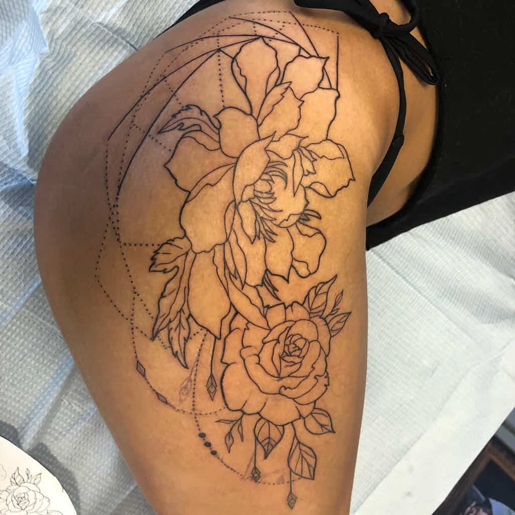 Line art of roses and geometric shapes tattooed on a woman's upper thigh