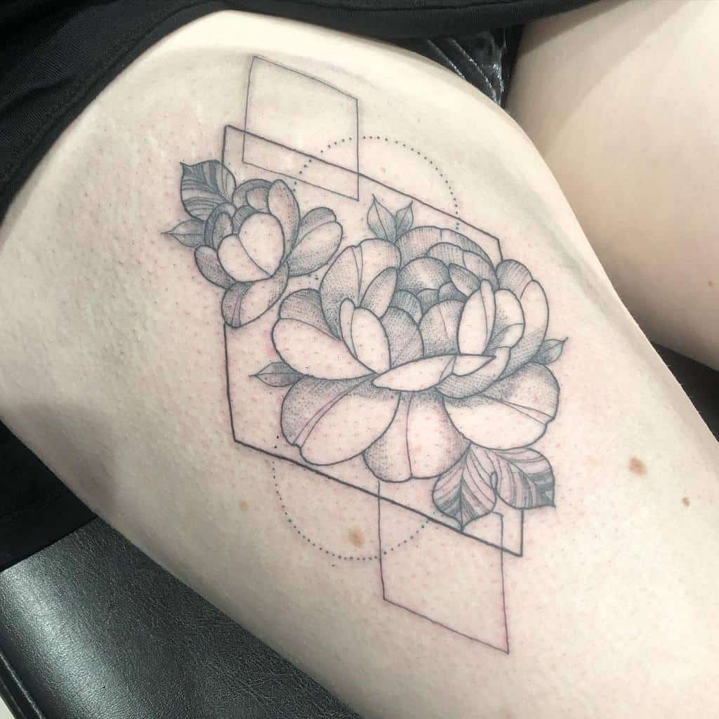 Geometric flower tattoo on upper thigh, featuring roses and triangular shapes in black ink