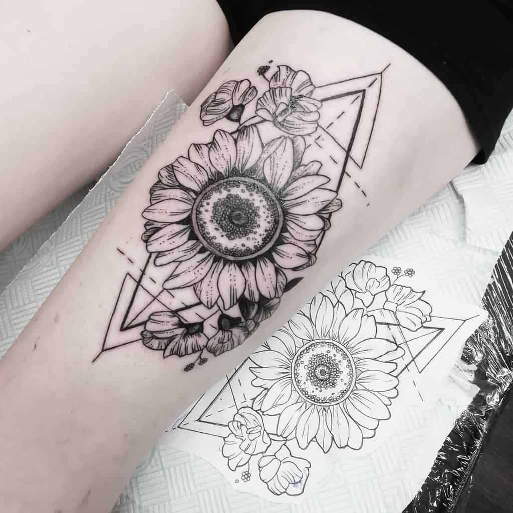 Black and white tattoo of a sunflower with geometric shapes on a thigh