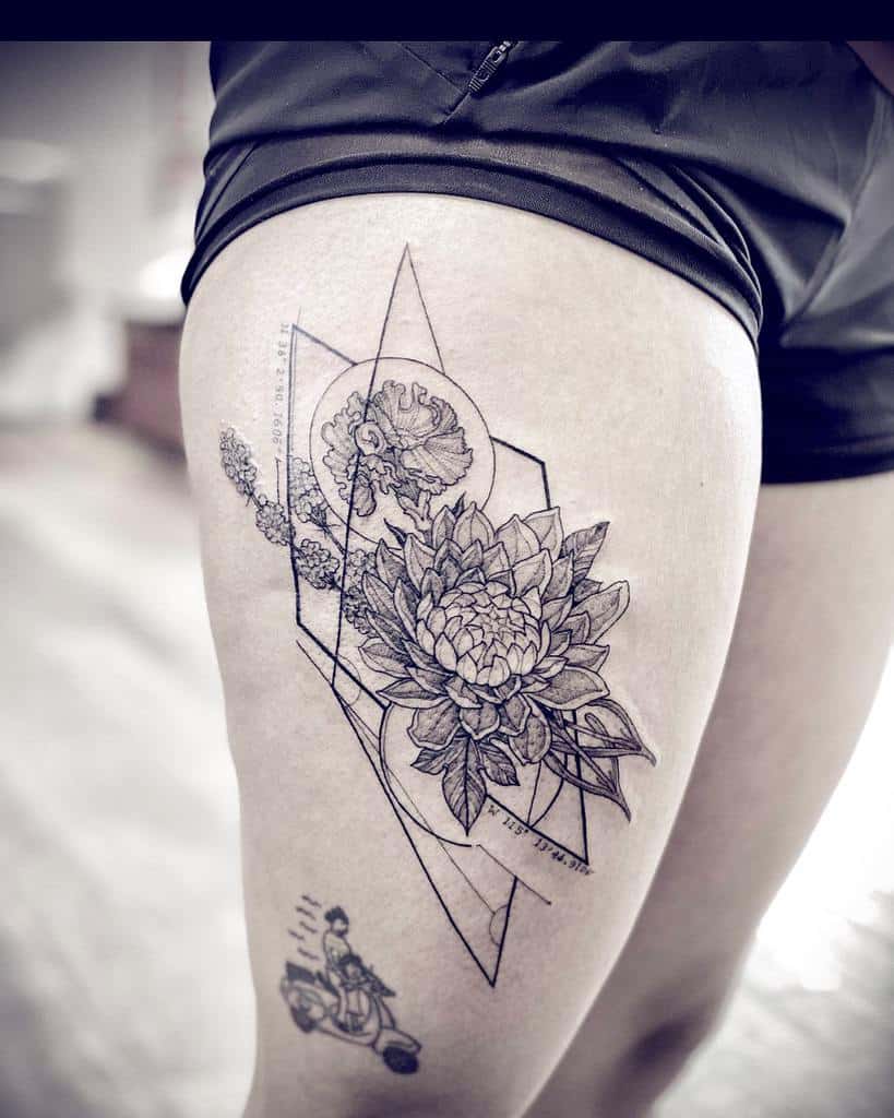 Thigh tattoo of a geometric floral design with overlapping shapes and detailed flowers