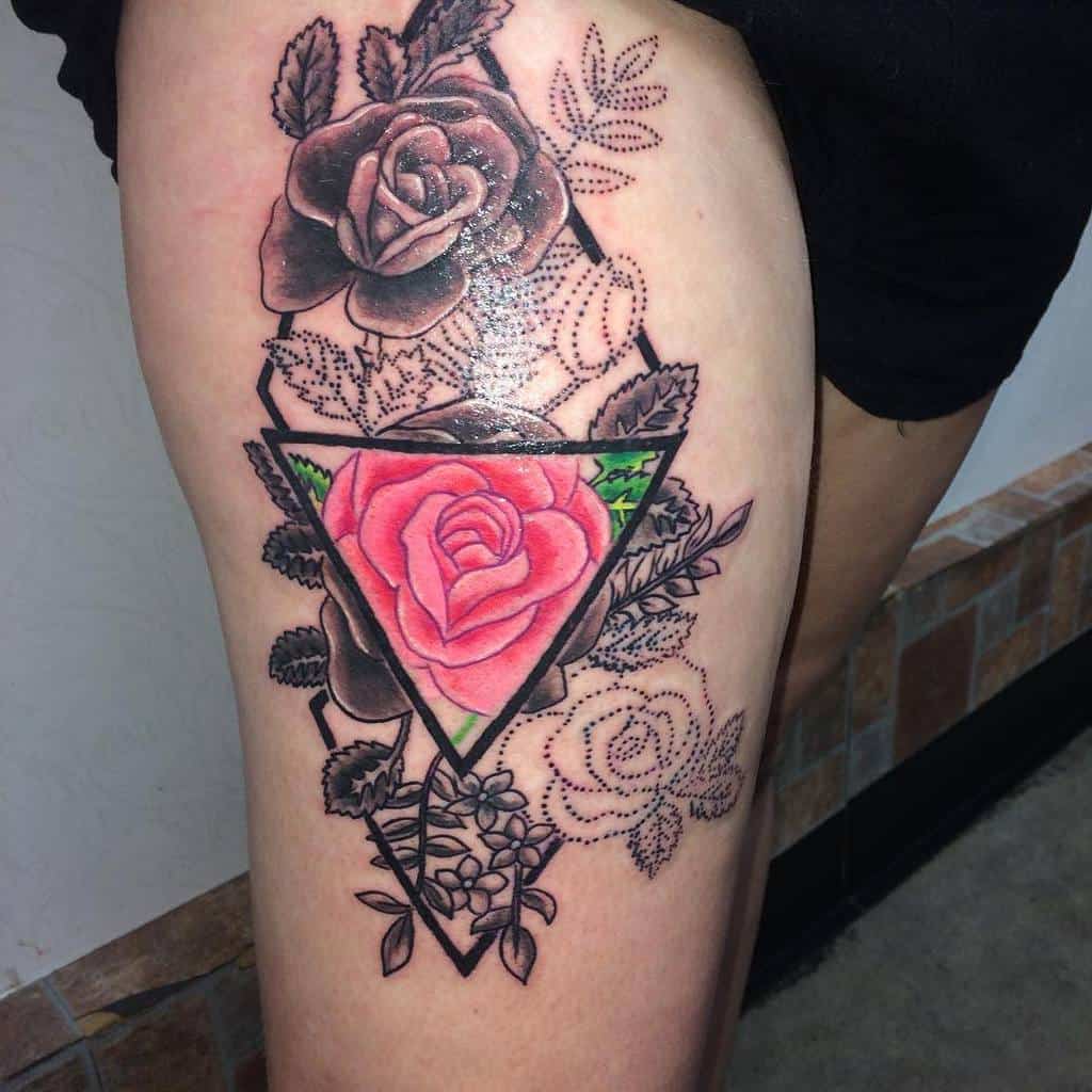 Tattoo of red and black roses within geometric shapes on a thigh