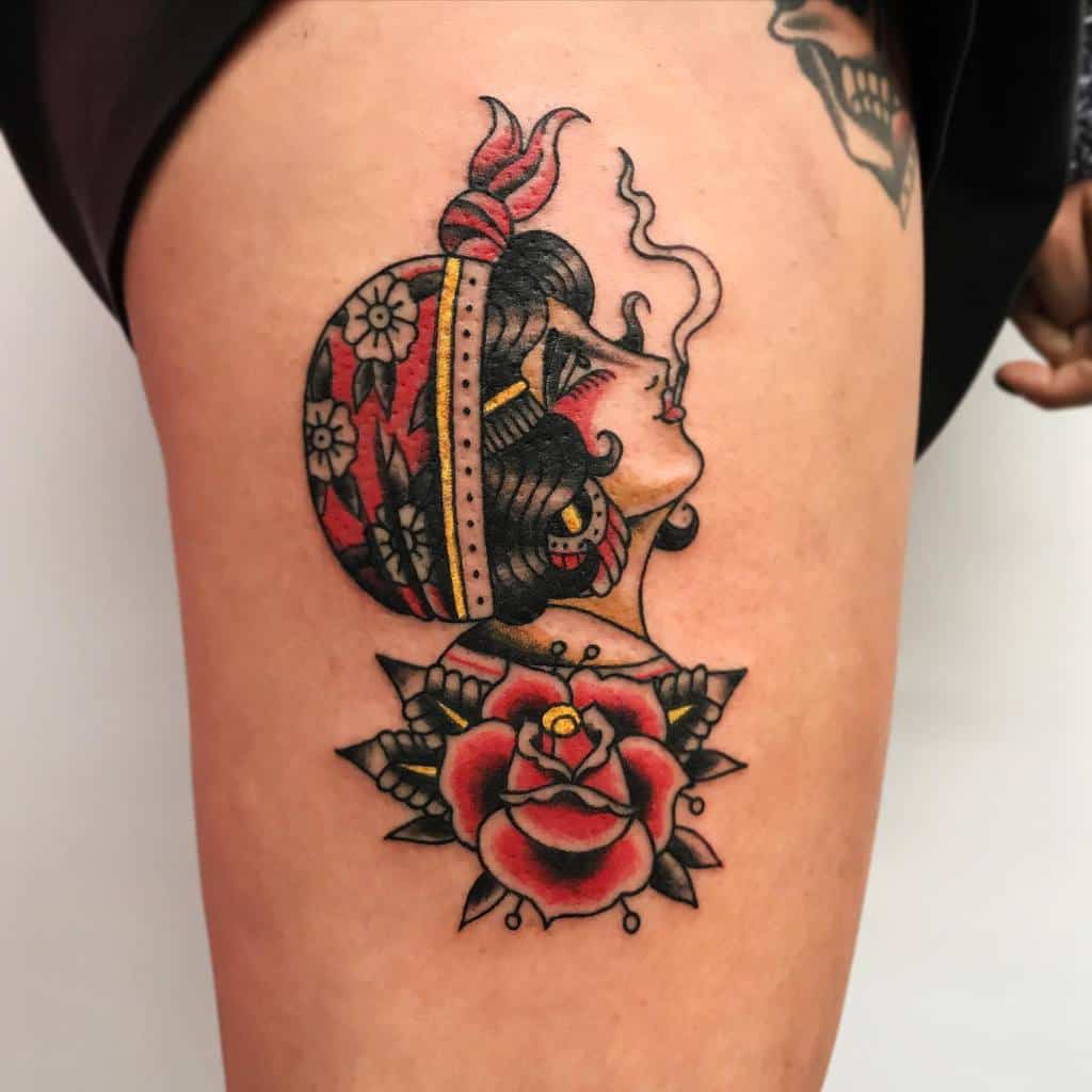 Tattoo of a gypsy woman in profile with flowers and a red rose on an upper thigh