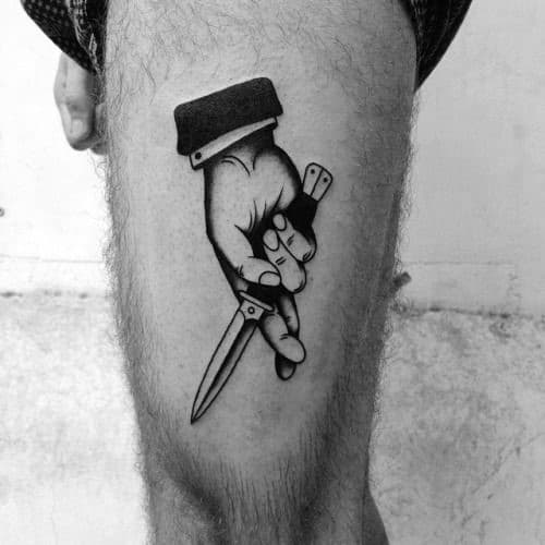Thigh Hand Holding Switchblade Tattoo Design On Man
