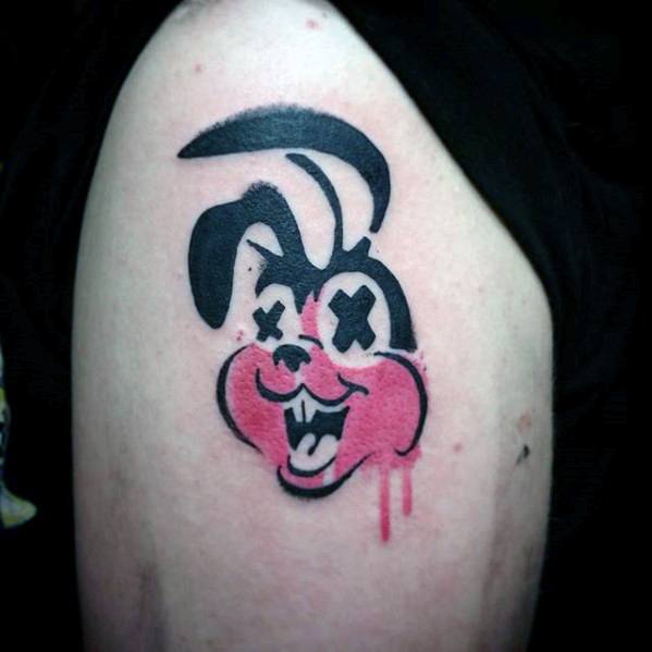 Tattoo of a cartoon bunny with X eyes, bright pink cheeks, and dripping ink detail, inspired by Green Day’s punk aesthetic.