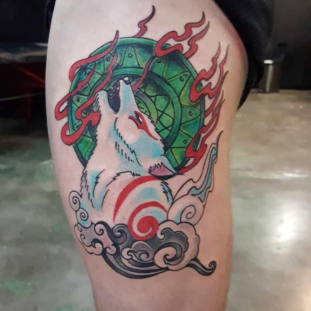 Tattoo of a white wolf with red markings, red flames, and a green circular background on a thigh