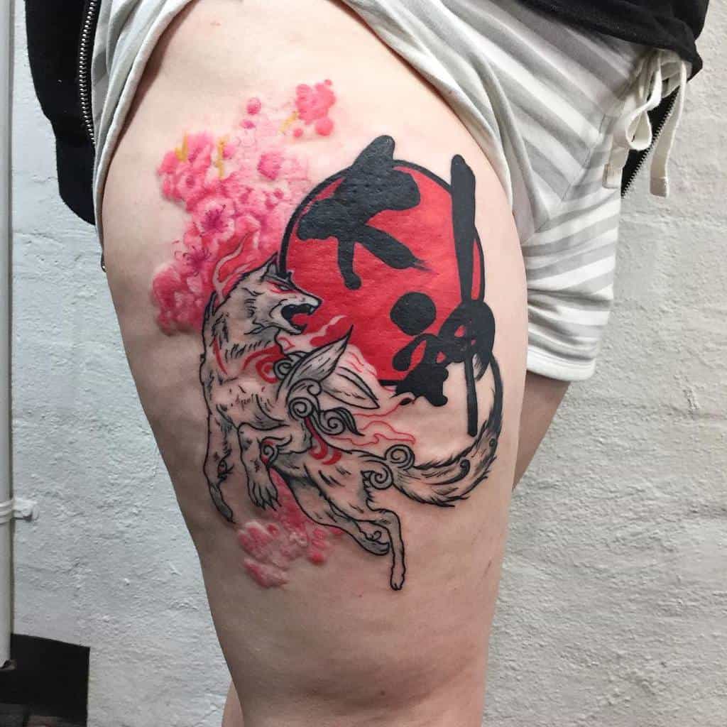 Thigh tattoo of a Japanese wolf with swirling patterns, a red sun, black kanji, and pink cherry blossoms in the background