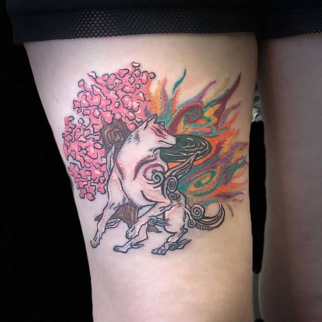 Tattoo of a stylized wolf with a pink tree and colorful flames on an upper thigh