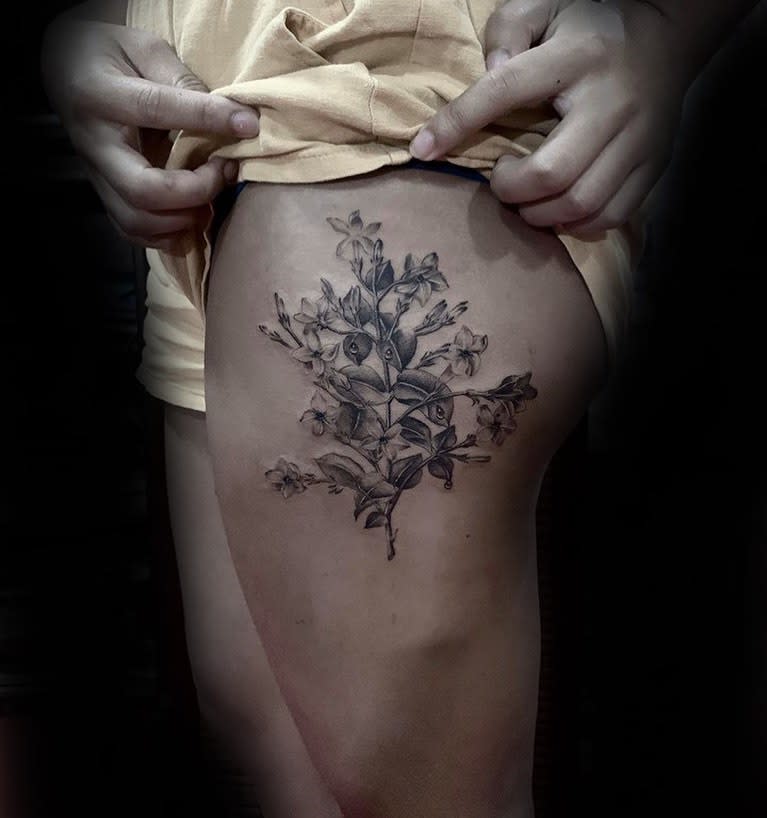 Detailed floral tattoo on the upper thigh