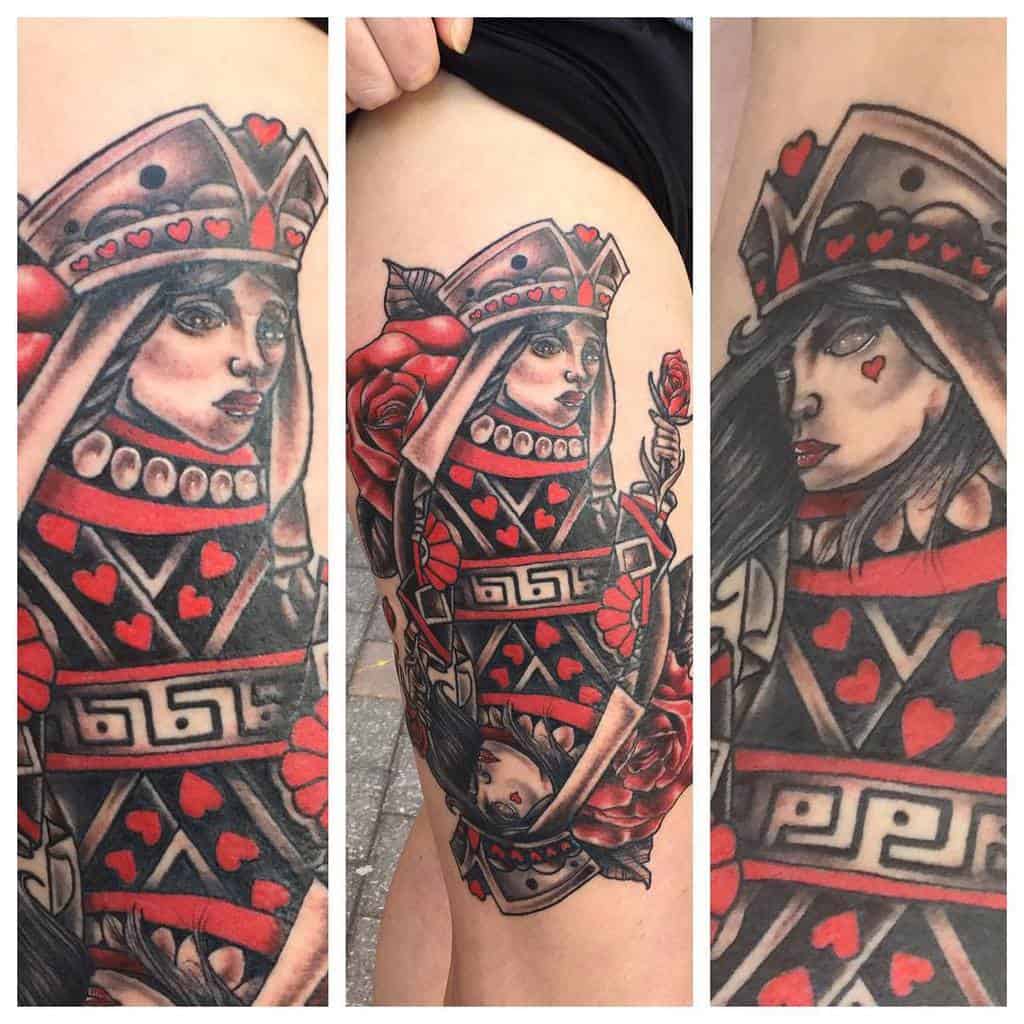 Tattoo of playing card queen with red and black details and roses on arm