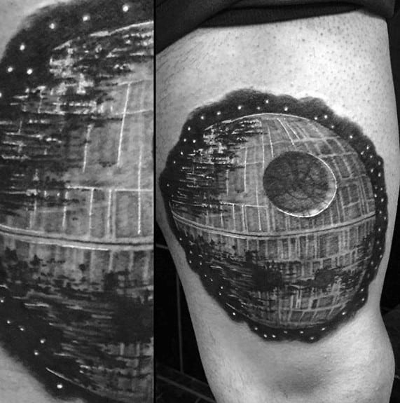 Death Star tattoo in black and white adorns a person's thigh