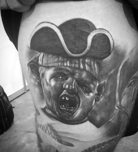 Black and gray realistic tattoo of Sloth from *The Goonies*, wearing a pirate hat and striped bandana, with detailed shading and depth.