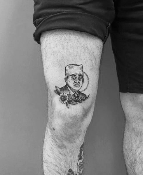 Black and white tattoo of Michael Scott as "Prison Mike" from *The Office*, featuring his iconic bandana with floral details below.