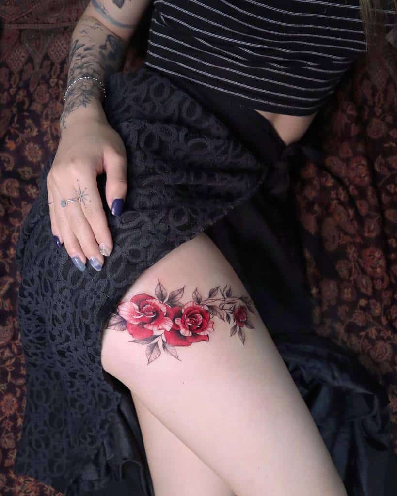 Tattoo of red roses on thigh
