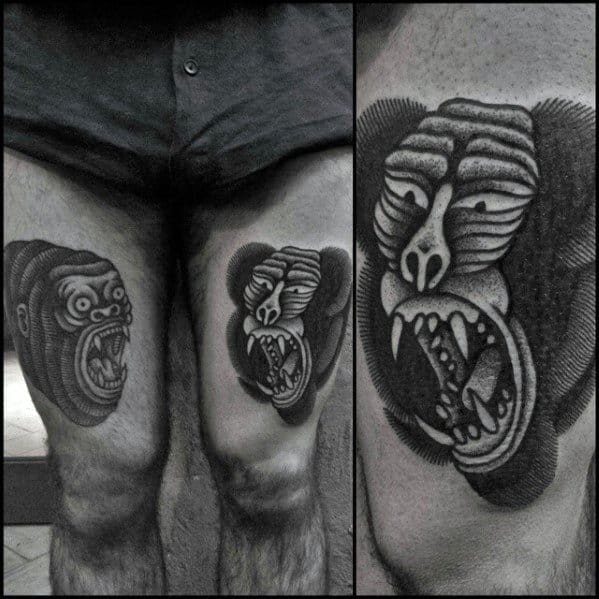 Blackwork baboon thigh tattoos with bold shading, surreal facial distortions, and fierce open-mouthed expressions for a striking and unique design.